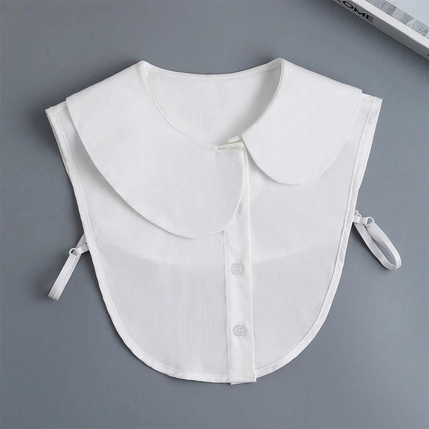 White collarless shirt on a gray background