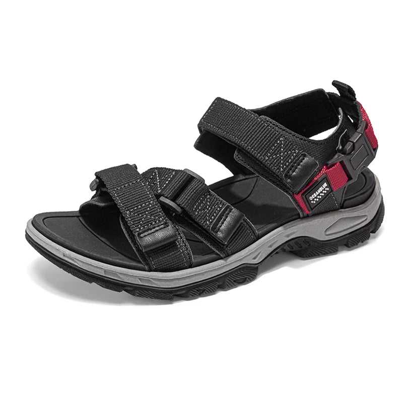 Black and gray sandal with red accents on a white background