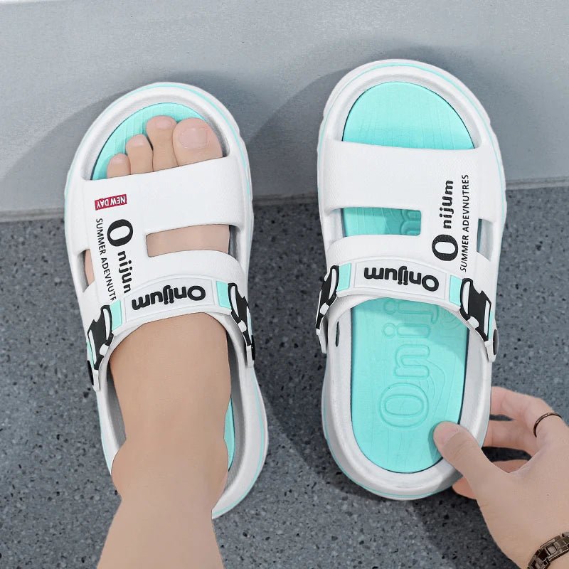 White sandals with turquoise soles on a gray floor