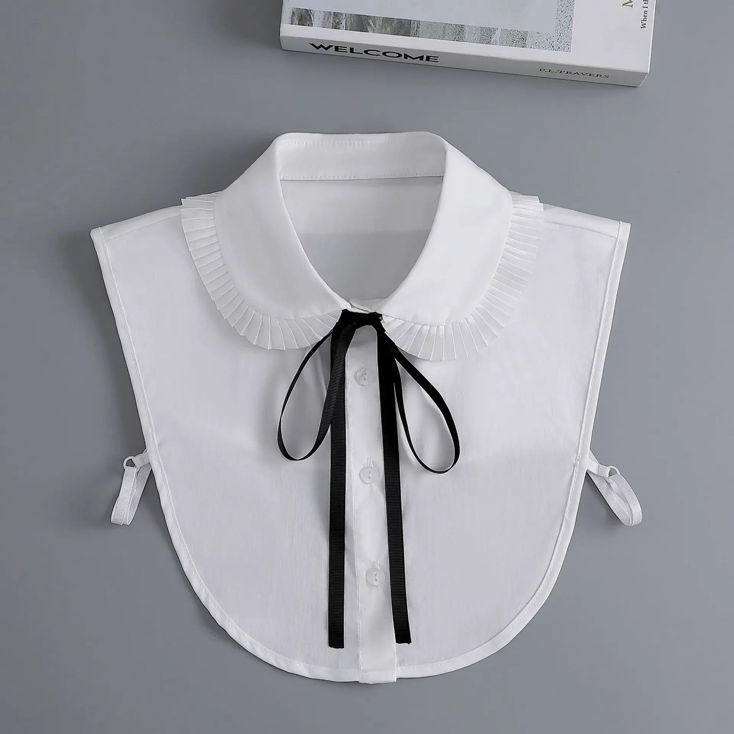White collar with black ribbon on a gray background