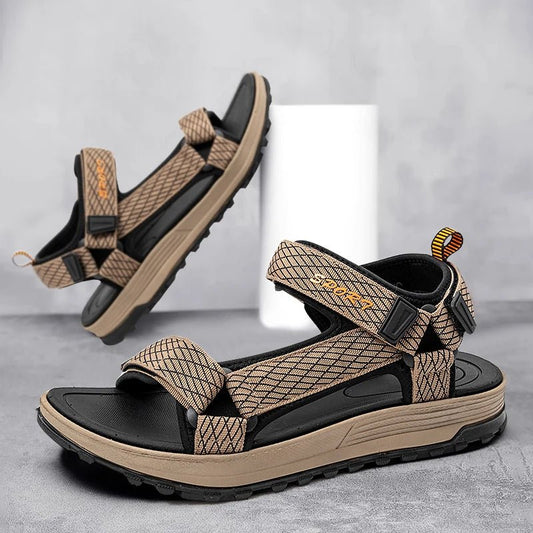 Pair of brown and black sandals on a gray background